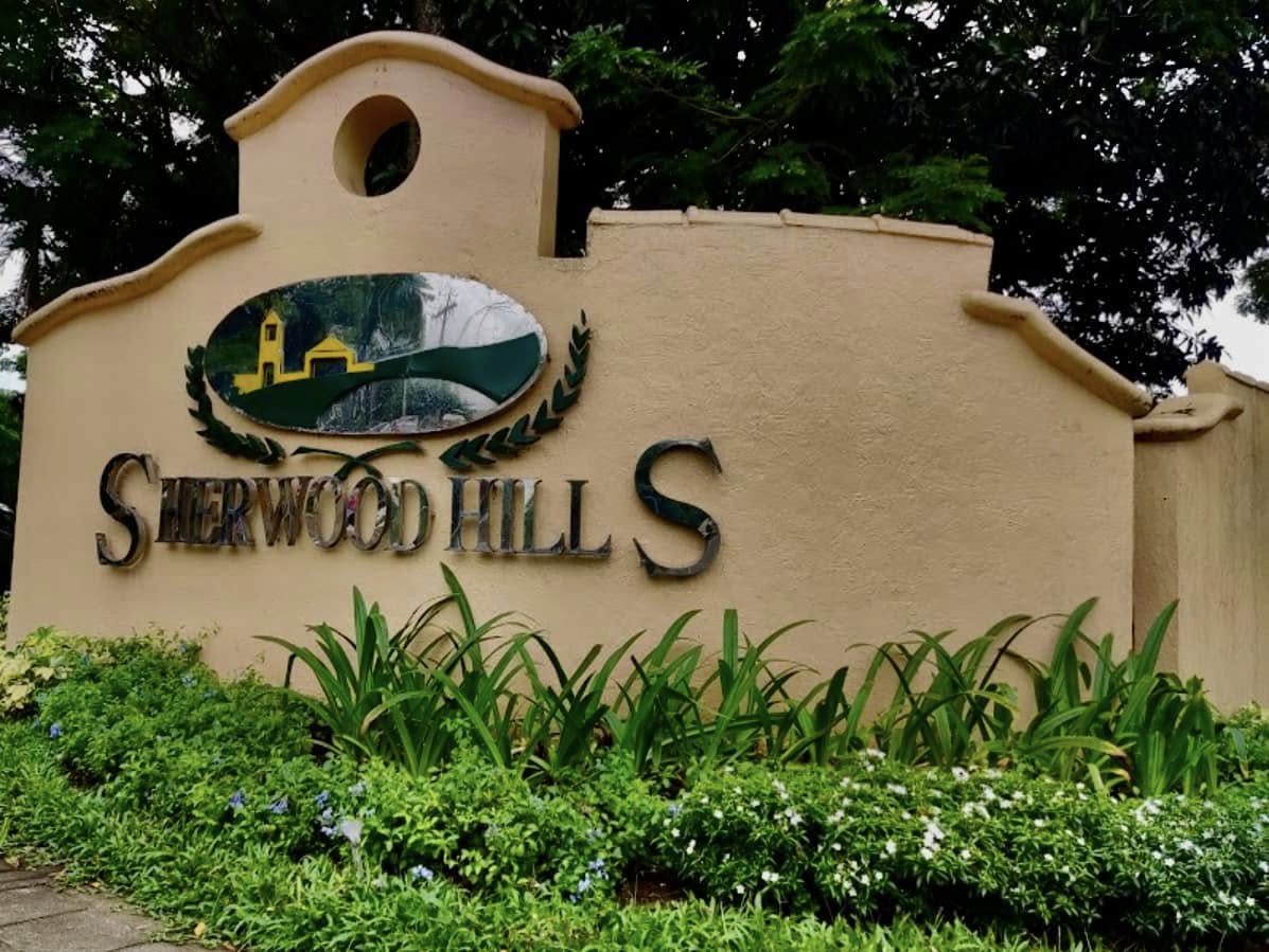 The entrance sign and landscaped grounds of Sherwood Hills